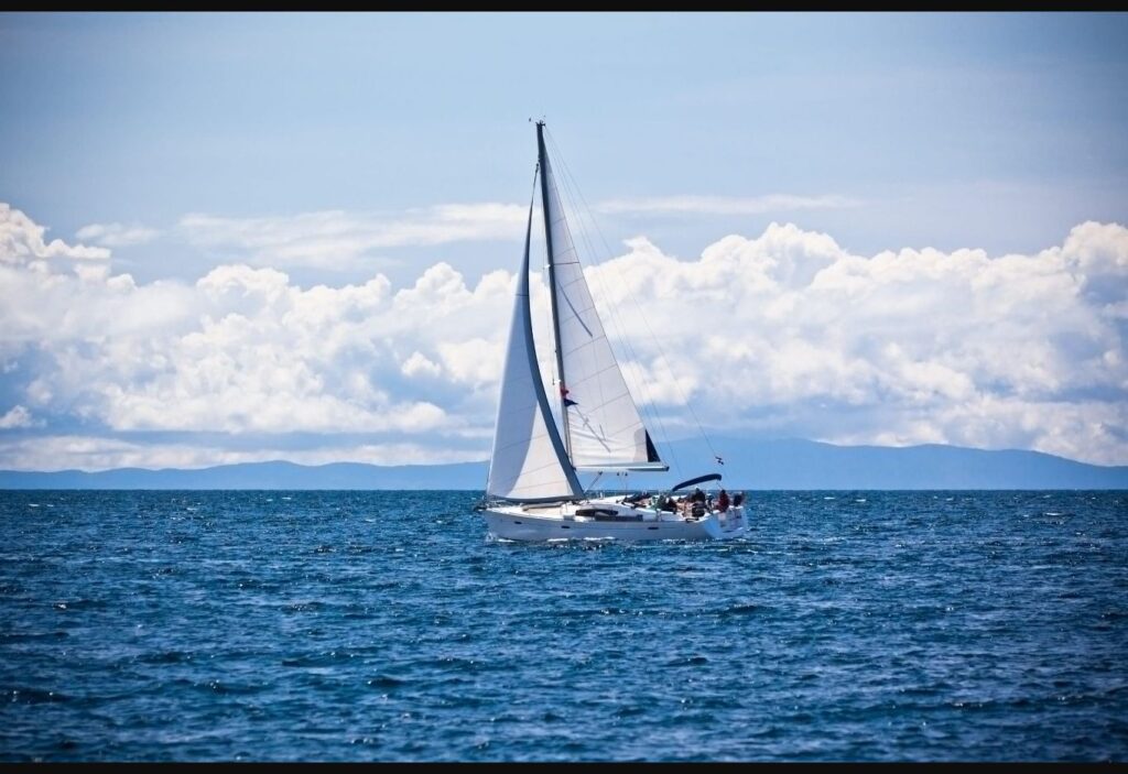 Sailboat crossing the Helsinki archipelago in summer