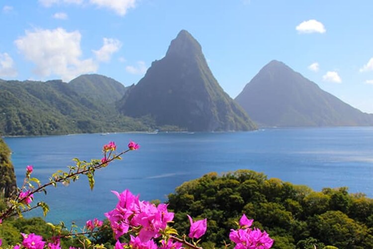 The Pitons, tropical greenery and blue sea in Saint Lucia