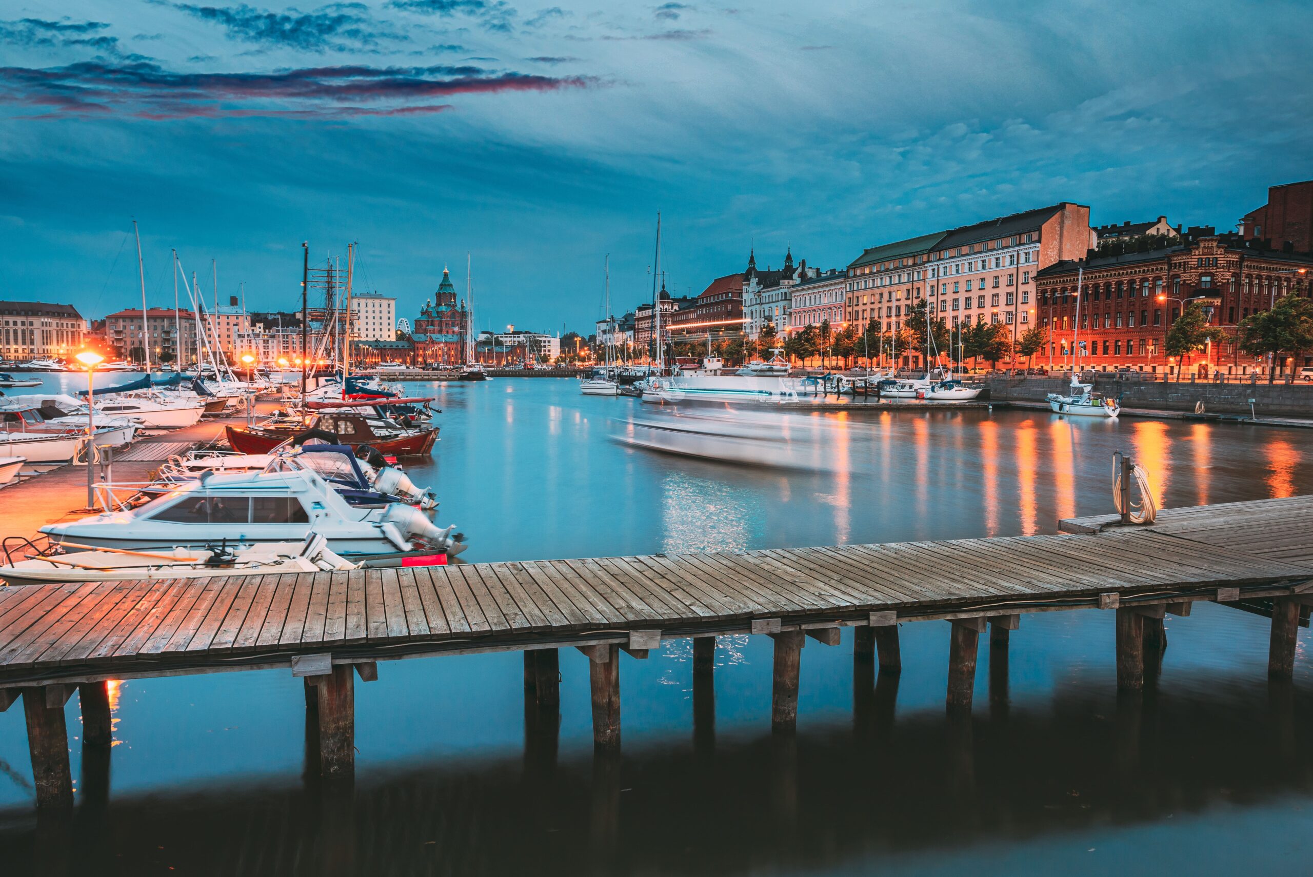 Boats and waterfront buildings in Helsinki South Harbour at dusk