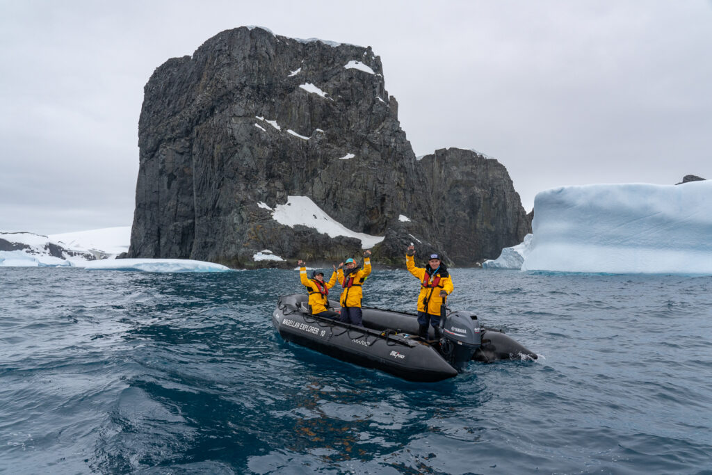 Antarctica21 expedition team in a Zodiac among icebergs