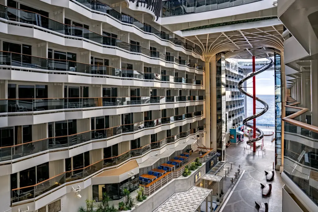 Open promenade on an MSC ship with balconies and a spiral slide